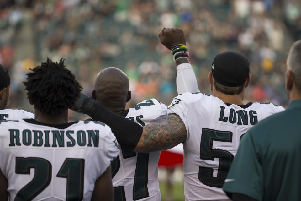 Eagles safety&nbsp;Malcolm Jenkins protests during the national anthem before a 2017 preseason game. Defensive end Chris Long became one of the first white NFL players to join the demonstrations. (Photo: Mitchell Leff/Getty Images)