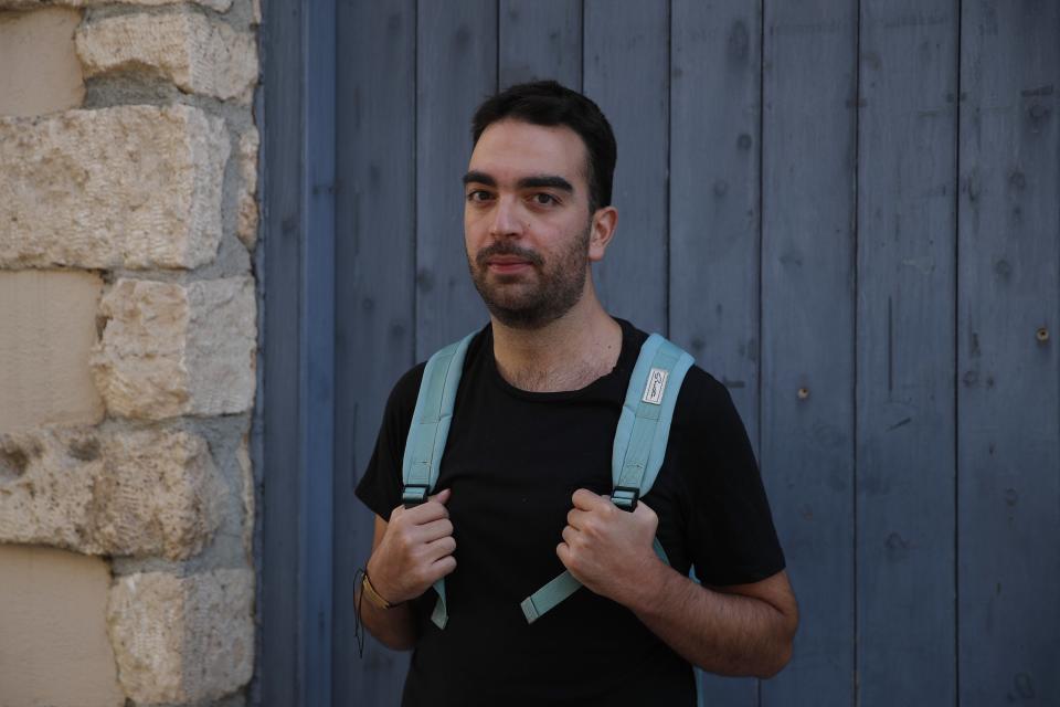 Actor and theater director Aris Laskos poses outside the Theater of Neos Kosmos in Athens, Thursday, Oct. 1, 2020. Laskos based in Athens, hasn't worked since early February and received a one-off support check for 800 euros ($940) shortly after the country's economy was placed in lockdown in the spring due to the pandemic. (AP Photo/Thanassis Stavrakis)