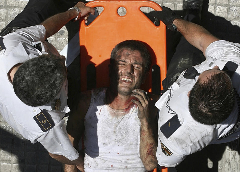 FILE - An injured passenger is carried away on a stretcher by policemen after a subway train derailed and overturned inside a tunnel in the eastern Mediterranean port city of Valencia, Spain, on July 3, 2006. Rail travel in Europe is a common and relatively affordable and convenient way for many Europeans to travel. It also has a good safety record overall, growing safer in past years. Yet the tragedy in Greece on Wednesday is a reminder of how deadly crashes can be when they happen. (AP Photo/Rafa Gil, File)