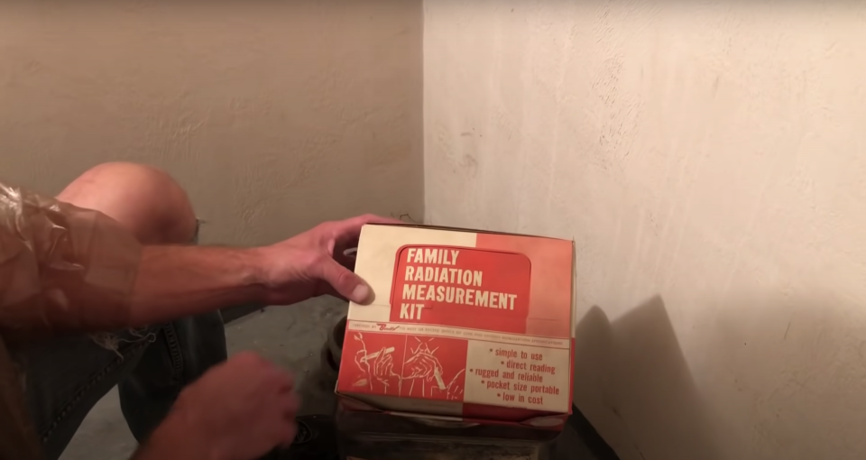 A man looks at a Family Radiation Measurement Kit from a Cold War Era bomb shelter.