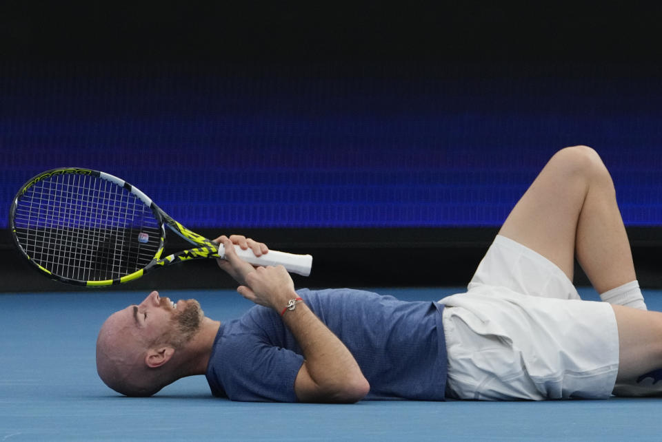 Adrian Mannarino of France lies on the court after a fall during United Cup semifinal tennis match against Poland's Hubert Hurkacz in Sydney, Australia, Saturday, Jan. 6, 2024. (AP Photo/Mark Baker)