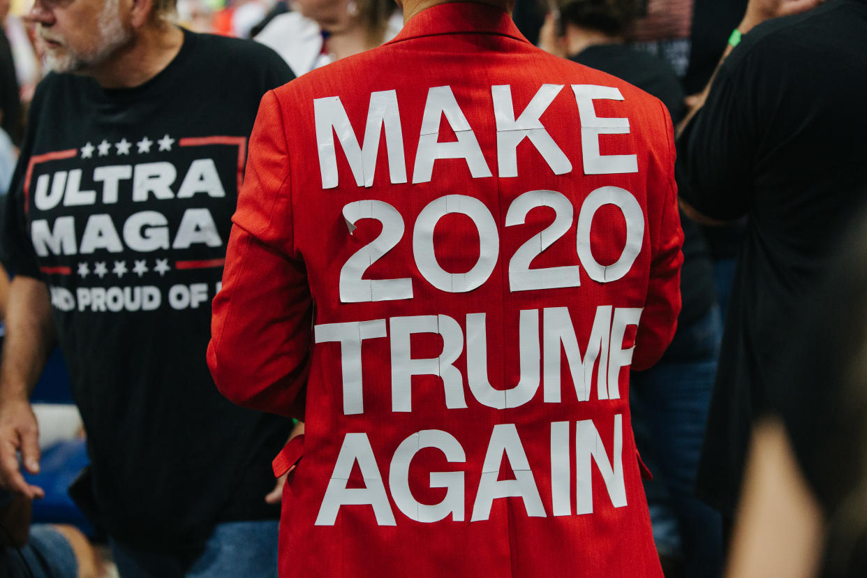 Attendees at a Trump rally wearing T-shirts saying: Ultra MAGA and Make 2020 Trump Again.