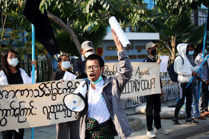 People protest on the street against the military after Monday's coup, outside the Mandalay Medical University in Mandalay