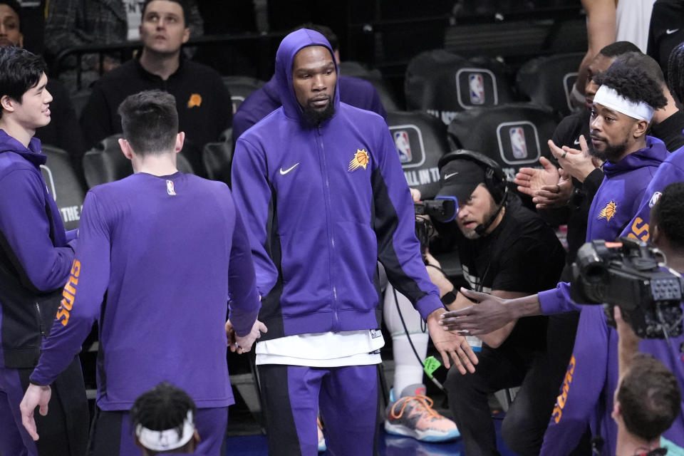 Phoenix Suns forward Kevin Durant, center is introduced as he arrives on the court before the start of an NBA basketball game against the Brooklyn Nets, Wednesday, Jan. 31, 2024, in New York. (AP Photo/Mary Altaffer)