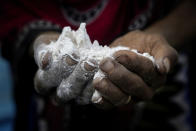 <p>Hagar Yahia, a Yemeni woman, shows the amount of flour she uses to make a loaf of bread, in this Feb. 15, 2018 photo taken in Abyan, Yemen. On the few good days when she or her husband find work, they may have some vegetables. But most often they eat a heavy bread called âtawaâ that fills the stomach longer, Yahia said. (Photo: Nariman El-Mofty/AP) </p>