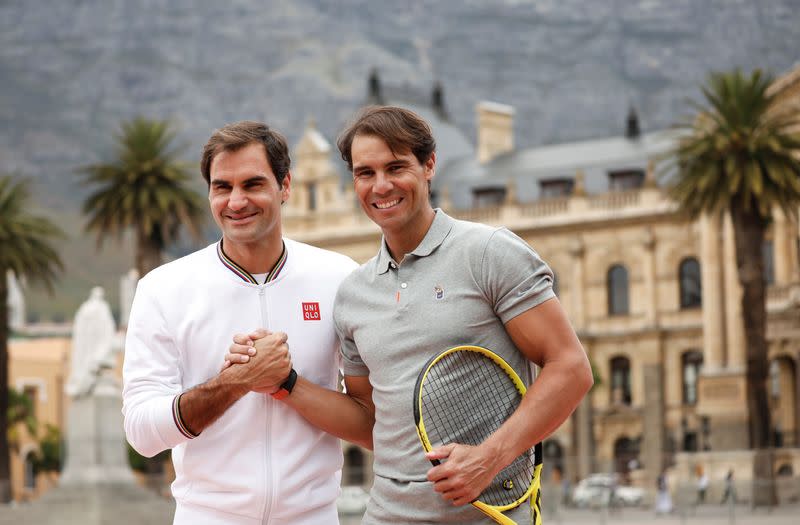 Roger Federer and Rafael Nadal pose for photographers ahead of their "Match in Africa" exhibition tennis match in Cape Town