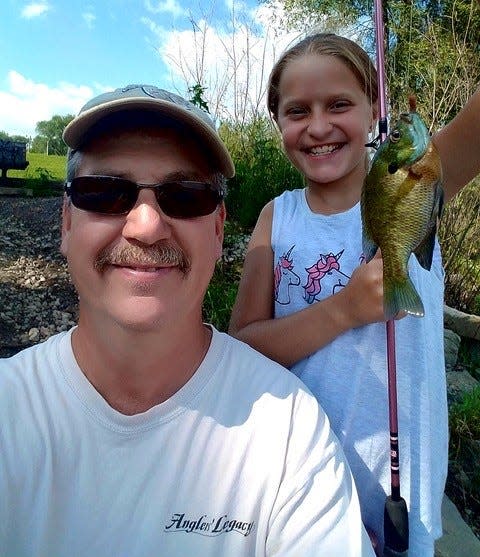 Dan Cohen and his granddaughter Ella Kisner enjoy a day fishing at a local park.