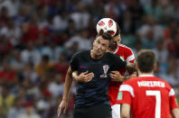 <p>Mario Mandzukic jumps for the ball with Russia’s Ilya Kutepov </p>