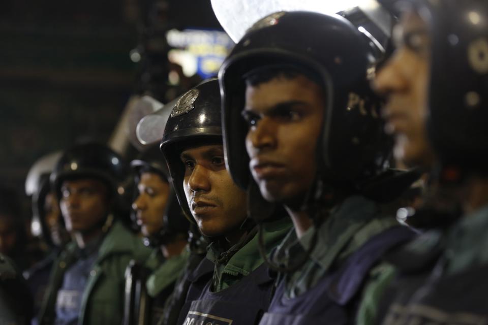 Police officers stand guard in front of the central jail in Dhaka