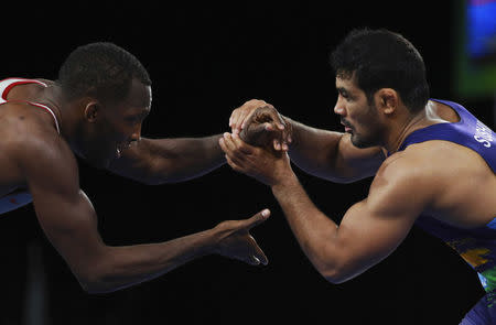 Wrestling - Gold Coast 2018 Commonwealth Games - Men's Freestyle 74 kg - 1/8 Final - Carrara Sports Arena 1 - Gold Coast, Australia - April 12, 2018. Jevon Balfour of Canada and Kumar Sushil of India compete. REUTERS/Athit Perawongmetha