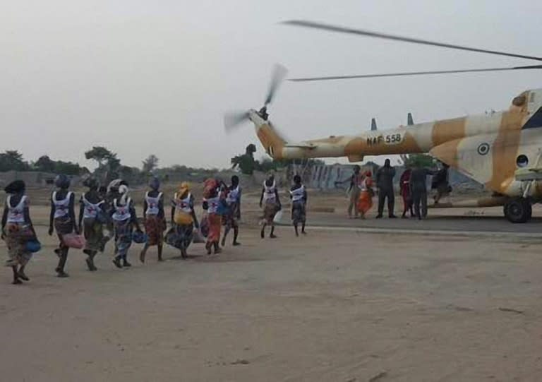 This handout image provided by the International Committee of the Red Cross (ICRC) on May 7, 2017 at a military base in Borno State shows some of the 82 rescued Chibok girls heading towards a Nigerian Army helicopter