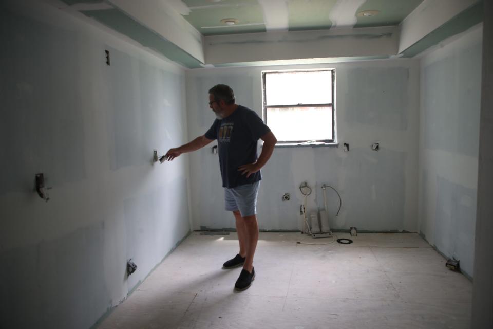 Mike Riley inspects some of the work done by contractors at his friend's condo in Island Park Village on Wednesday, Sept. 20, 2023, in Fort Myers.