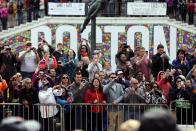 Race fans photograph and cheer for runners competing in the 118th Boston Marathon, Monday, April 21, 2014, in Boston. (AP Photo/Robert F. Bukaty)