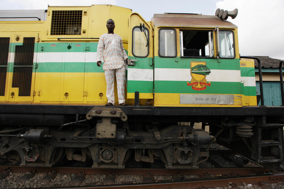 In this Photo taken, Friday, March . 8, 2013, A train driver stand on an Ooni of Ife train to Kano, in Lagos, Nigeria. Nigeria reopened its train line to the north Dec. 21, marking the end of a $166 million project to rebuild portions of the abandoned line washed out years earlier. The state-owned China Civil Engineering Construction Corp. rebuilt the southern portion of the line, while a Nigerian company handled the rest. The rebirth of the lines constitutes a major economic relief to the poor who want to travel in a country where most earn less than $1 a day. Airline tickets remain out of the reach of many and journeys over the nation's crumbling road network can be dangerous. The cheapest train ticket available costs only $13. ( AP Photo/Sunday Alamba)
