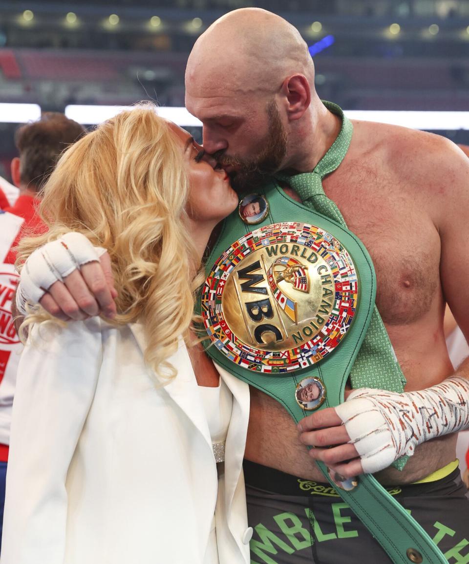 Tyson Fury celebrates victory with their wife Paris Fury after the WBC World Heavyweight Title Fight between Tyson Fury and Dillian Whyte at Wembley Stadium on April 23, 2022 in London, England.