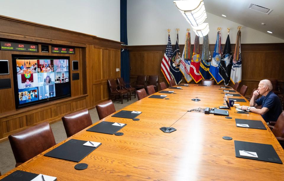 In this White House handout, U.S. President Joe Biden and Vice President Kamala Harris (on screen) hold a video conference with the national security team to discuss the ongoing efforts to draw down forces in Afghanistan.