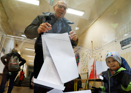 A man casts his vote during the Polish regional elections, at a polling station in Warsaw, Poland, October 21, 2018. REUTERS/Kacper Pempel