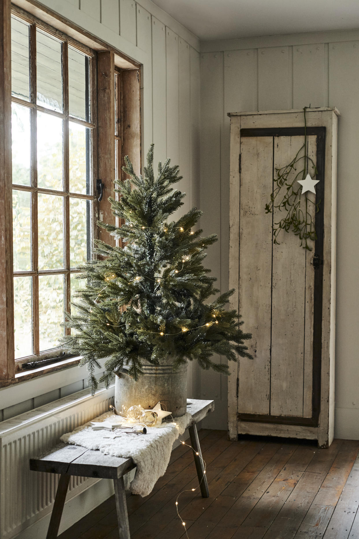  Small Christmas tree on console table by Neptune. 