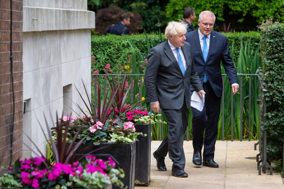 LONDON, ENGLAND - JUNE 15: UK Prime Minister Boris Johnson (L) and Australian Prime Minister Scott Morrison in the garden of 10 Downing Street, after agreeing the broad terms of a free trade deal between the UK and Australia, on June 15, 2021 in London, England. The leaders met as the two countries announced one of Britain's first post-Brexit trade deals. (Photo by Dominic Lipinski - WPA Pool/Getty Images)