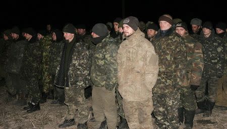 Ukrainian prisoners of war get ready to be exchanged for members of pro-Russian separatists near the village of Zholobok in Luhansk region, eastern Ukraine, February 21, 2015. REUTERS/Igor Tkachenko