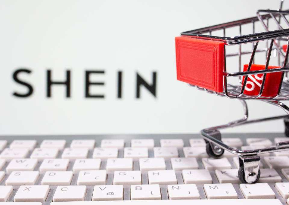 A keyboard and a shopping cart are seen in front of a displayed Shein logo in this illustration picture taken October 13, 2020. REUTERS/Dado Ruvic/Illustration