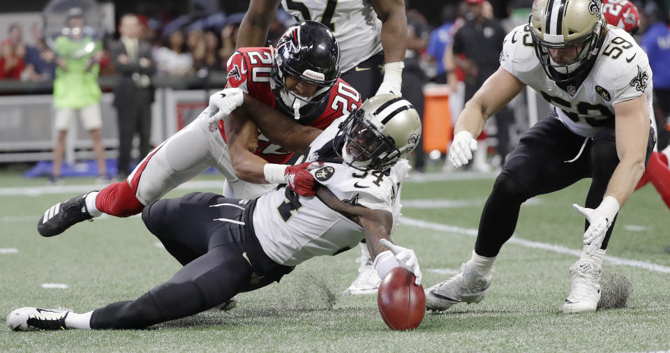 New Orleans Saints defensive back Justin Hardee (34) and Atlanta Falcons cornerback Isaiah Oliver (20) vie for a loose ball after a blocked punt during the second half of an NFL football game, Sunday, Sept. 23, 2018, in Atlanta. (AP Photo/Mark Humphrey)