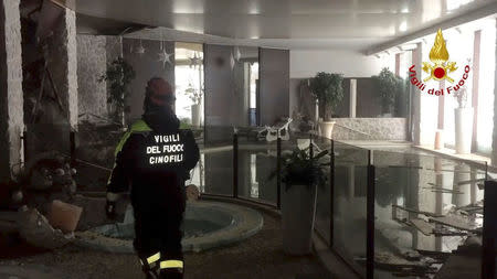 A firefighter walks inside Hotel Rigopiano in Farindola, central Italy, after it was hit by an avalanche, in this handout picture released on January 20, 2017 provided by Italy's Fire Fighters. Vigili del Fuoco/Handout via REUTERS