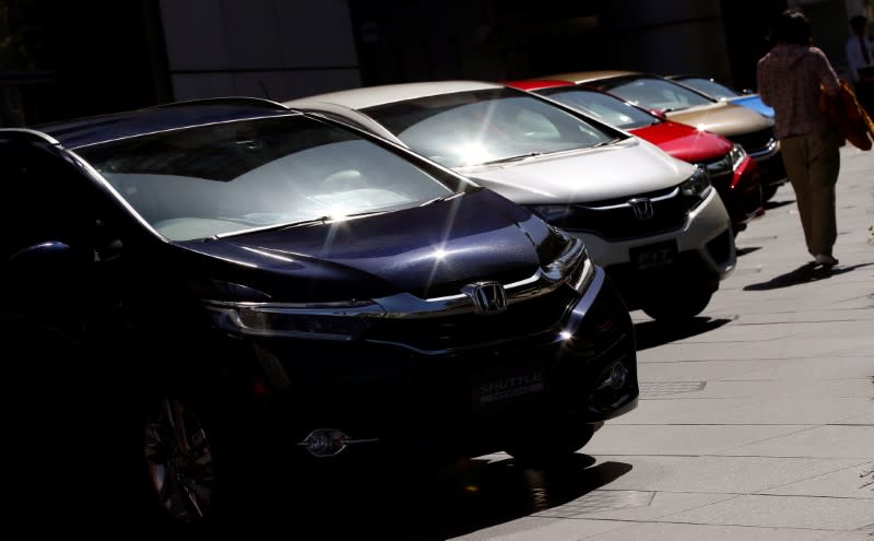 A woman walks past Honda Motor cars outside the company's showroom in Tokyo, Japan, May 13, 2016. REUTERS/Toru Hanai