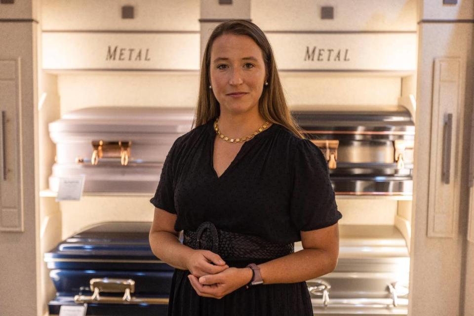 Virginia Kerr Zoller, acting manager for Kerr Brothers Funeral Home, stands within a room of example caskets offered for services within the funeral home, on Sept. 13, 2023.