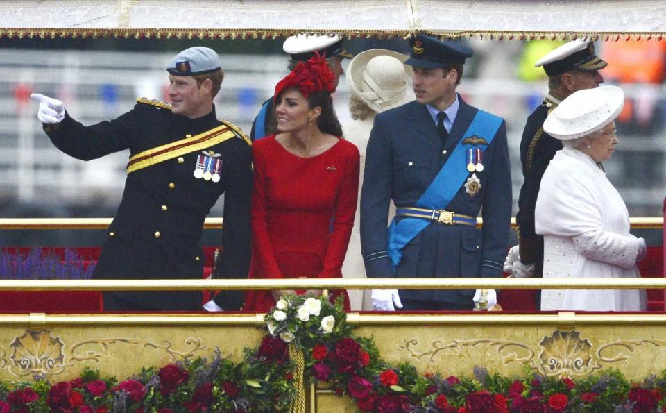 Britain's Kate Duchess of Cambridge, 2nd left,  stands next to Prince Harry, left  Prince William, 3rd left,  and Queen Elizabeth  as they watch the proceeding onboard the Royal barge during the Queen's Diamond Jubilee Pageant on the River Thames   in London Sunday June 3, 2012. More than 1,000 boats will sail down the River Thames on Sunday in a flotilla tribute to Queen Elizabeth II's 60 years on the throne that organizers are calling the biggest pageant on the river for 350 years.  (AP Photo/Dylan Martinez, Pool)