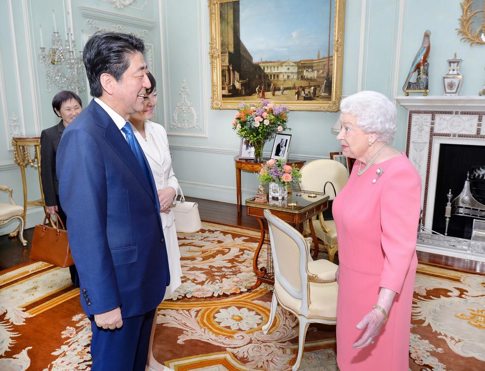 Queen Elizabeth II greets the Prime Minister of Japan Shinzo Abe and wife Akie