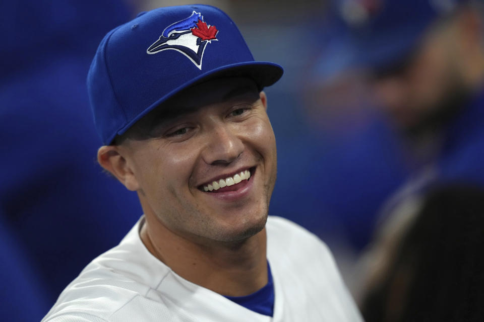 Toronto Blue Jays Cam Eden smiles in the dugout after his first at-bat with the team, against the Tampa Bay Rays during the eighth inning of a baseball game Friday, Sept. 29, 2023, in Toronto. (Chris Young/The Canadian Press via AP)
