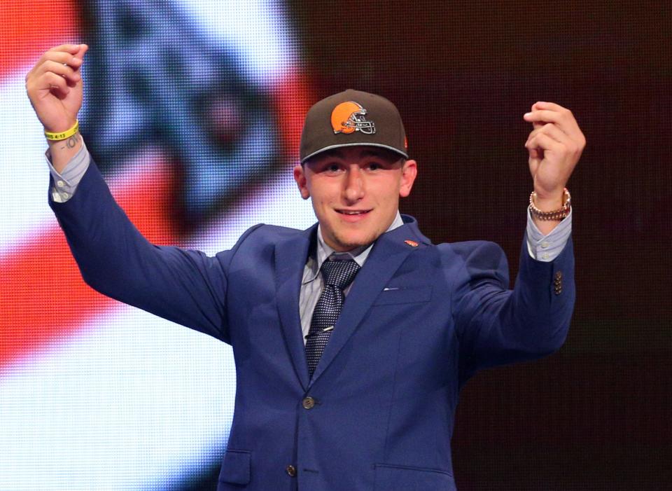 Johnny Manziel gestures on stage after being selected by the Browns during the first round of the 2014 NFL draft at Radio City Music Hall in New York on May 8, 2014
