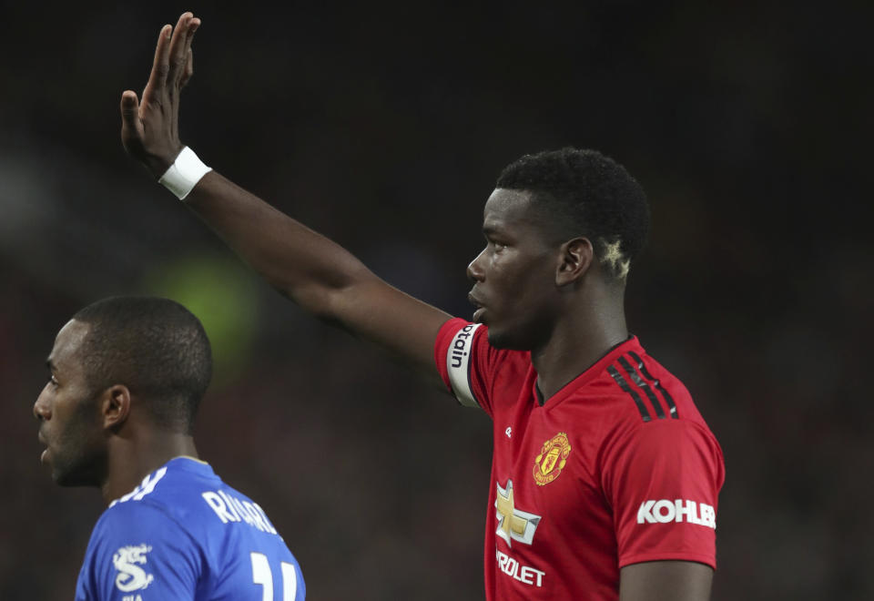 Manchester United's Paul Pogba, gestures to a teammates and who has two gold stars colouring the back of his head, a reference to the 2 World Cups that France have won, the during the English Premier League soccer match between Manchester United and Leicester City at Old Trafford, in Manchester, England, Friday, Aug. 10, 2018. (AP Photo/Jon Super)