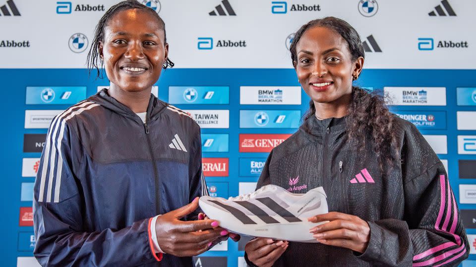 Assefa (right) displays her Adidas shoe ahead of the Berlin Marathon in September. - Luciano Lima/Getty Images