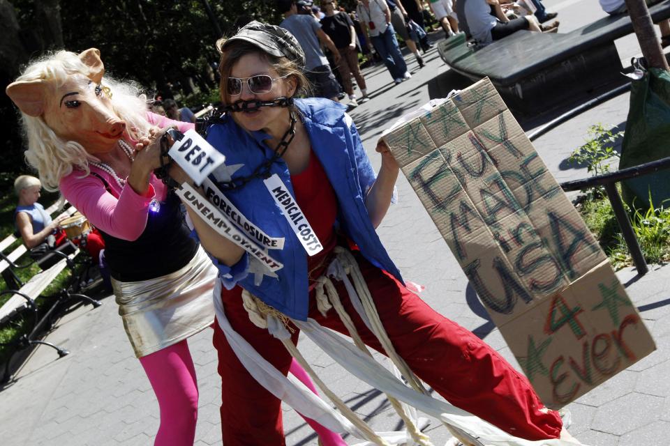 Activist associated with the Occupy Wall Street movement perform a skit during a gathering of the movement in Washington Square park, Saturday, Sept. 15, 2012 in New York. The Occupy Wall Street movement will mark it's first anniversary on Monday. (AP Photo/Mary Altaffer)