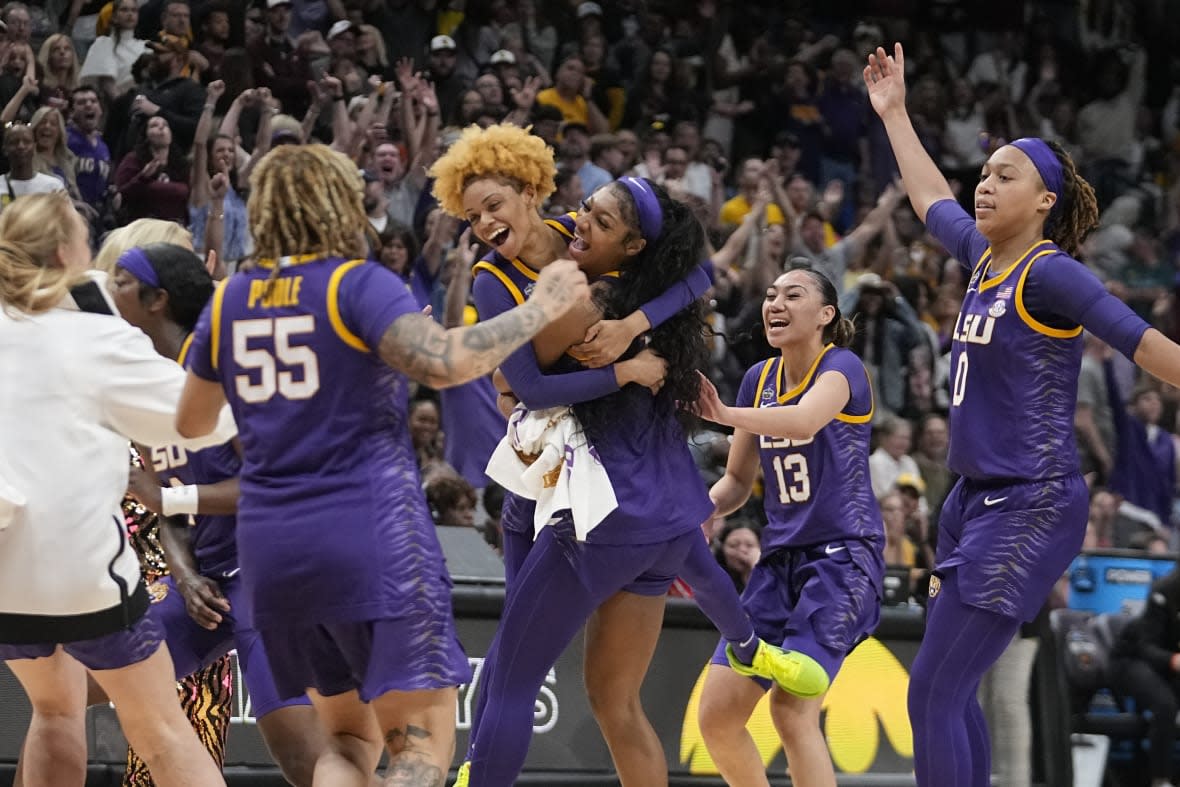 LSU players celebrate a last second shot during the first half of the NCAA Women’s Final Four championship basketball game against Iowa Sunday, April 2, 2023, in Dallas. (AP Photo/Darron Cummings)
