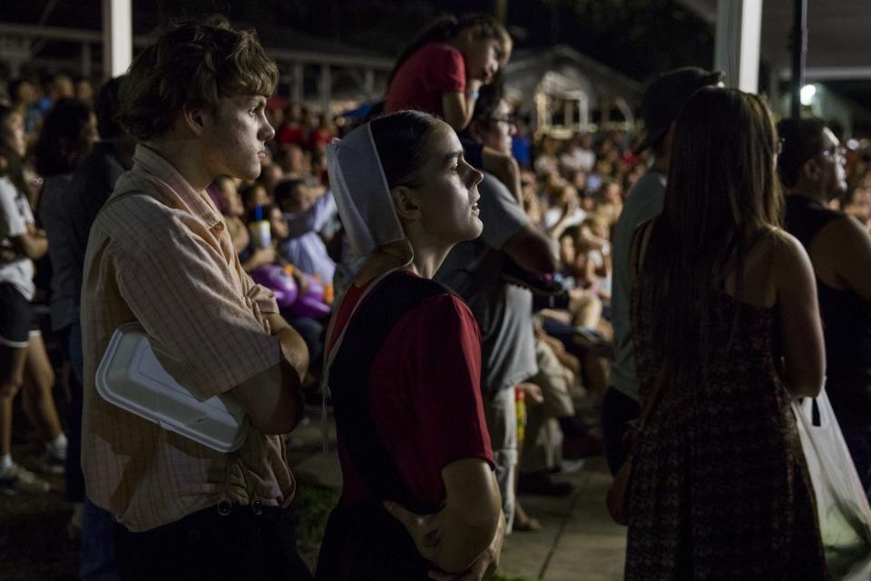 Two Amish teens watch a hypnotist try to get volunteers from the crowd to do things during a comedy show at the Montgomery County Agricultural Fair in Gaithersburg, Md., United States on August 19, 2017.