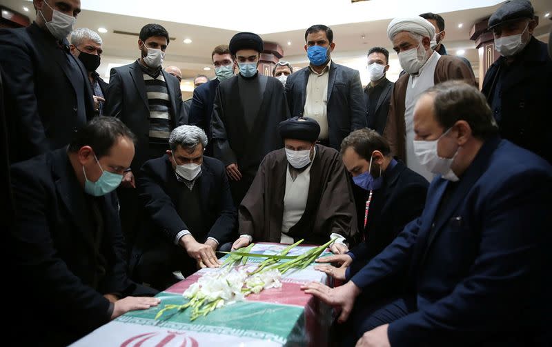 Mourners gather around the coffin of Iranian nuclear scientist Mohsen Fakhrizadeh at the Imam Khomeini's Shrine in Tehran