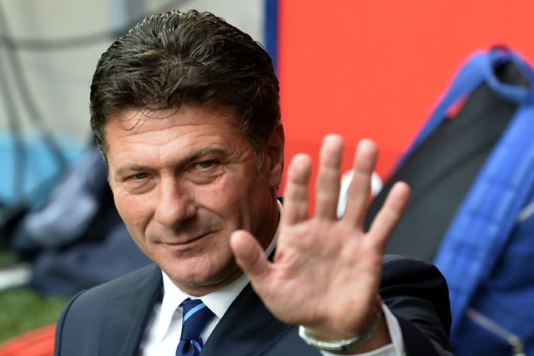 Former Inter Milan coach and current Watford Walter Mazzarri waves during the Serie A football match Inter Milan vs Genoa at San Siro Stadium in Milan on August 25, 2013
