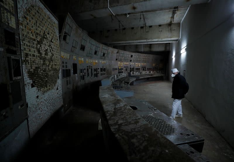 An employee walks at a control centre of the damaged fourth reactor at the Chernobyl Nuclear Power Plant