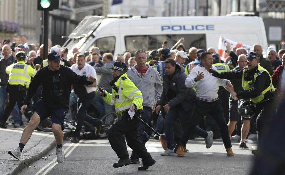 Police stop a breakaway from the main Football Lads alliance march, as they attempt to get close to a rival anti-facist demonstration in London, Saturday, Oct. 13, 2018. (AP Photo/Alastair Grant)