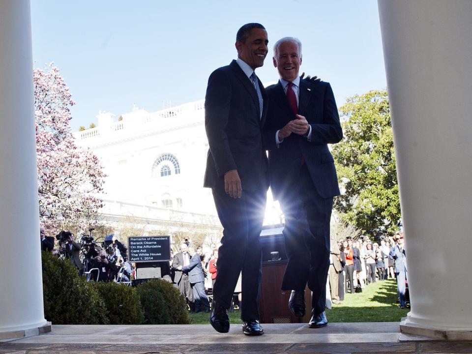 US President Barack Obama walks back to the Oval Office with Vice President Joe Biden after he delivered a statement on the Affordable Care Act at the Rose Garden of the White House in Washington, DC, on April 1, 2014. Obama cheered seven million people who signed up for insurance under his health care law, and lashed out at political foes who he said were bent on denying care to Americans.