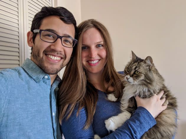 The author, center, with partner Joshua Truong and their cat, Waffle Cone, in 2018.