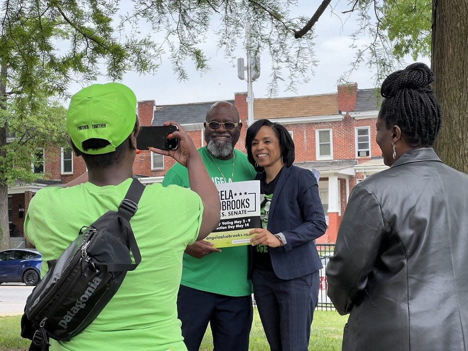 Prince George's County Executive Angela Alsobrooks, a Democratic candidate for United States Senate, center right, poses for a photograph with supporter Costello Wilson, center left, outside a polling place in Baltimore on primary Election Day May 14, 2024.