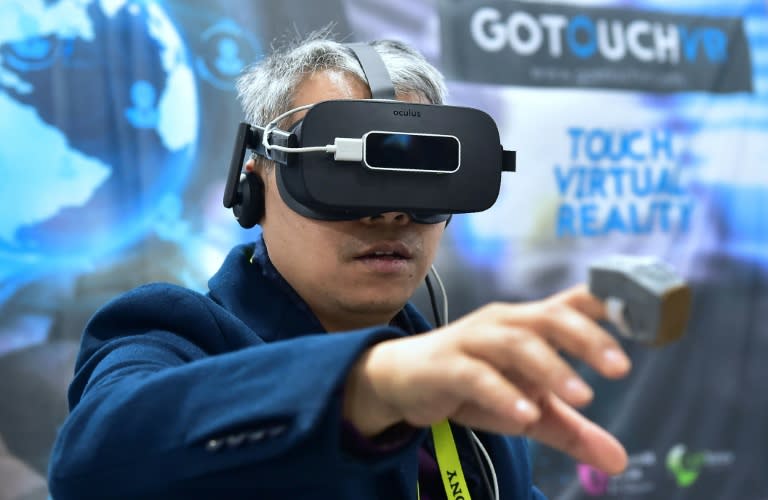 A man tries out the VR Touch, a wearable haptic ring creating the illusion of touching virtual objects, at the 2017 Consumer Electronic Show in Las Vegas