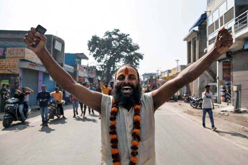 A Sadhu or a Hindu holy man celebrates after Supreme Court's verdict on a disputed religious site, in Ayodhya