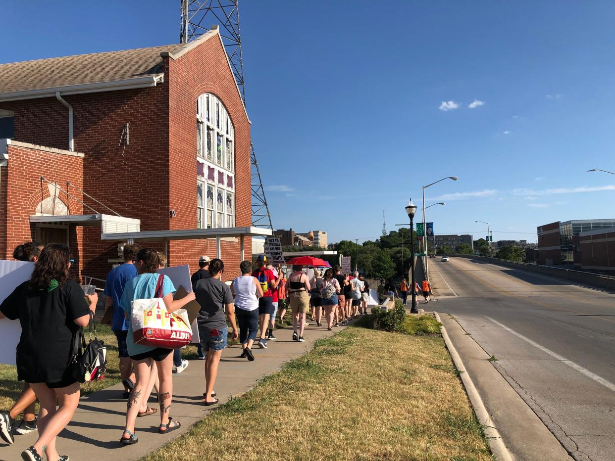 Participants march south along Benton Avenue toward Park Central Square on Saturday, July 23, 2022. The march to protect abortion rights was led by the Springfield NAACP's youth council.