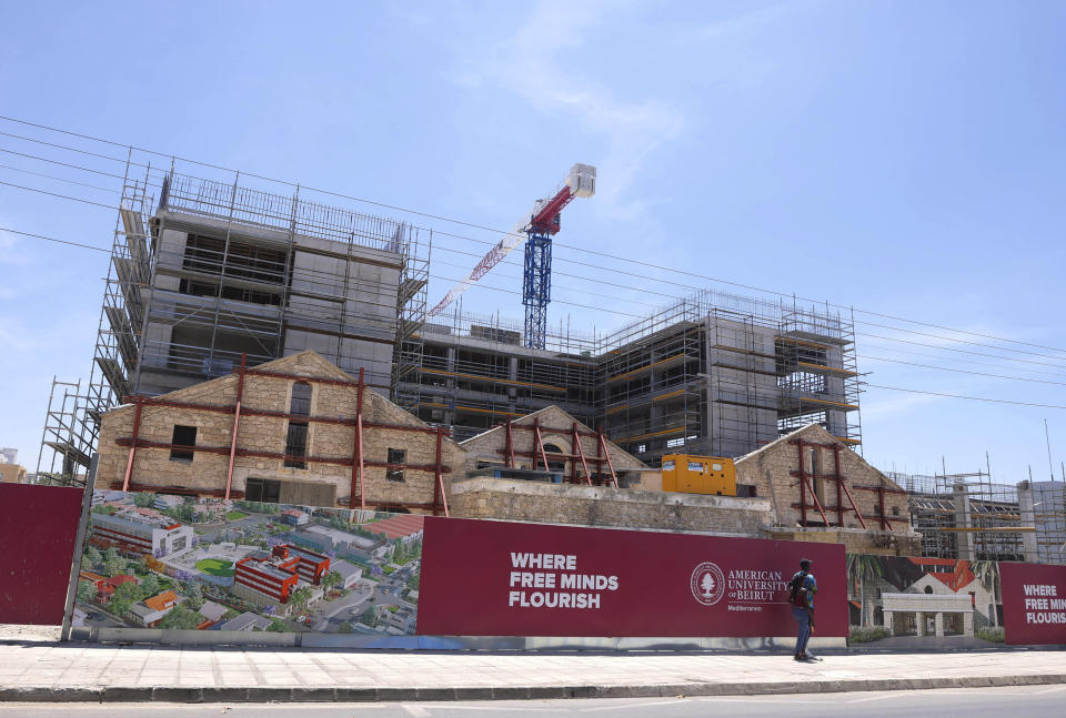 In this photo provided by Cyprus Press and Information Office, a man walks by the American University of Beirut building under construction, in the western coastal city of Paphos, Cyprus, Wednesday, June 7, 2023. Cyprus bested 15 other countries as the most suitable to host the American University of Beirut's first overseas campus, the president of the world-renowned institution said. It's part of the university's expansion plan that was initiated in 2018 but was expedited following the catastrophic Beirut port explosion in August 2020. (Stavros Ioannides /Cyprus Press and Information Office via AP)