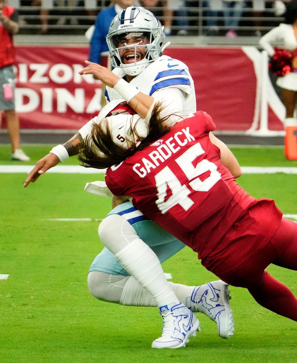 Sep 24, 2023; Glendale, Arizona, USA; Arizona Cardinals linebacker Dennis Gardeck (45) tackles Dallas Cowboys quarterback Dak Prescott (4) in the first at State Farm Stadium. Mandatory Credit: Rob Schumacher-Arizona Republic